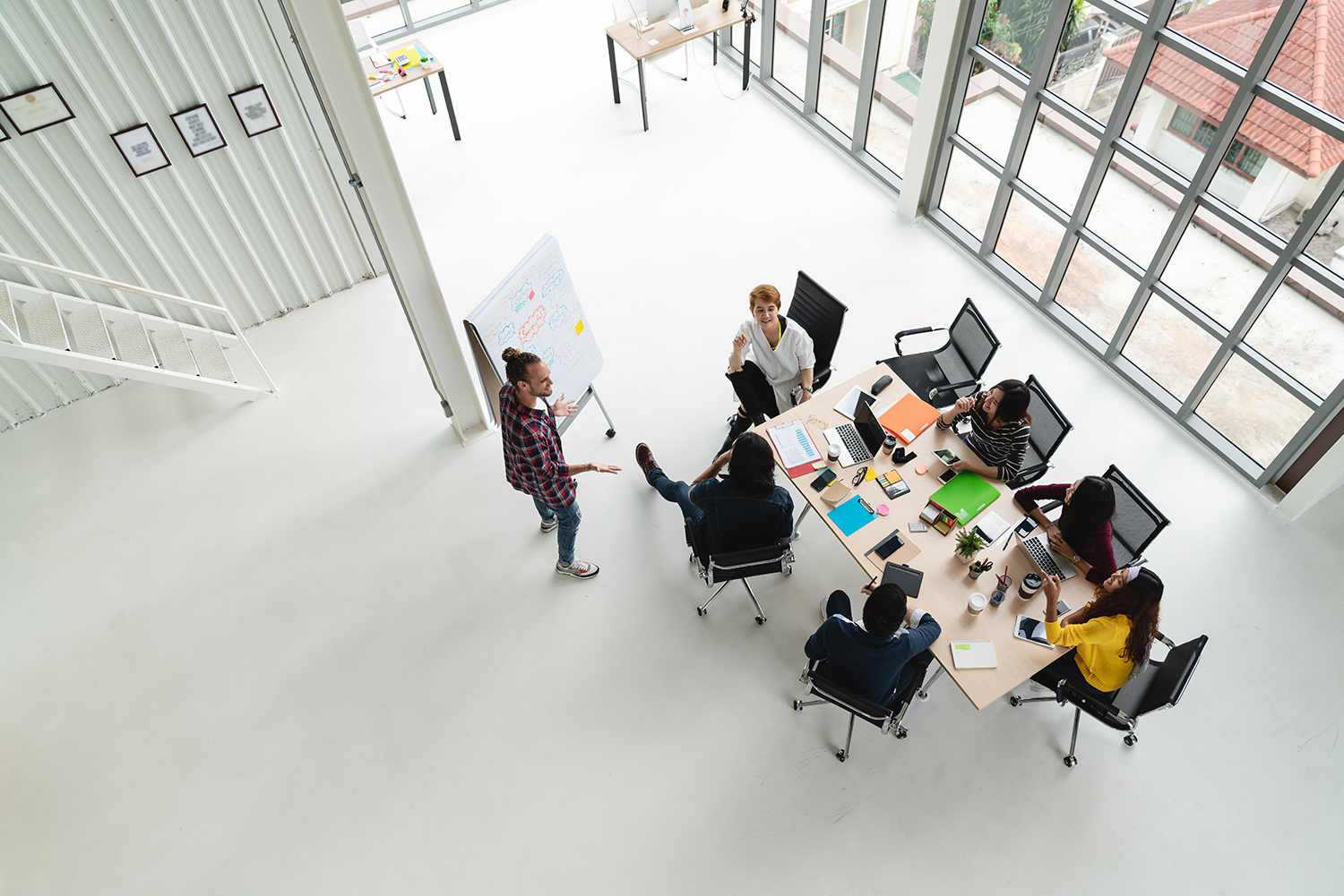 Top view of diverse people of creative team group using smartpho